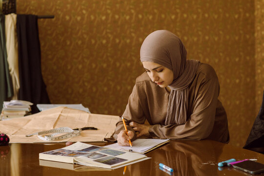 A young Muslim female fashion designer