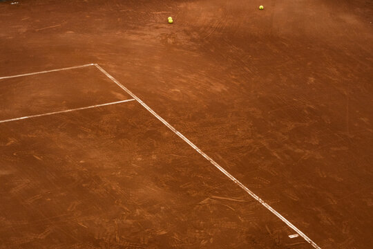 Tennis court with balls and lines.