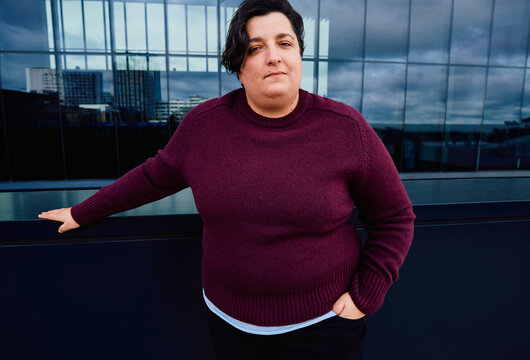 Young woman dressed in casual business  standing in a business area.