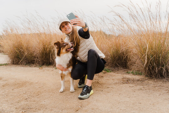 Loving Woman Taking Selfie With Her Dog