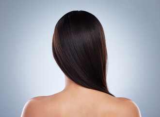 Fototapeta premium Back, model and hair care in studio with beauty for luxury salon treatment, shampoo and cosmetics. Woman, smile and glow or shine with healthy texture, transformation or growth on white background