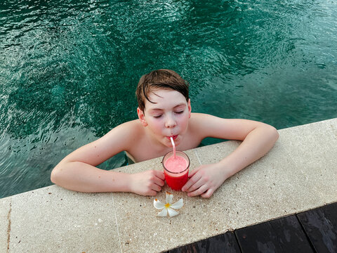 Boy Sipping Smoothie by the Sea