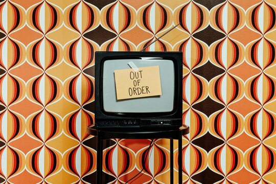 sign with the text out of order on a television set
