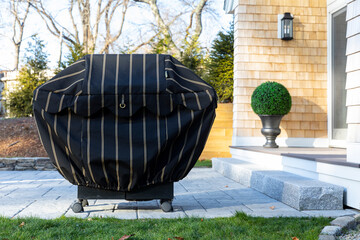 Outdoor barbecue Grill with cover at backyard deck exterior home 