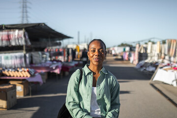 black woman buying clothes at a flea market