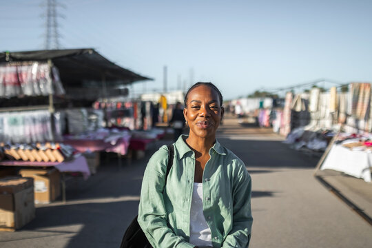 black woman buying clothes at a flea market