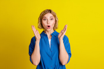 Portrait of pretty young lady open mouth wear blue shirt isolated on yellow color background
