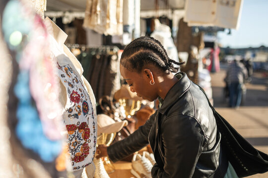 black woman buying clothes at a flea market
