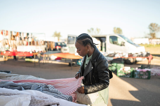 black woman buying fabrics at a market
