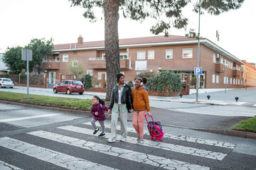 black mother on the way to school with her daughters