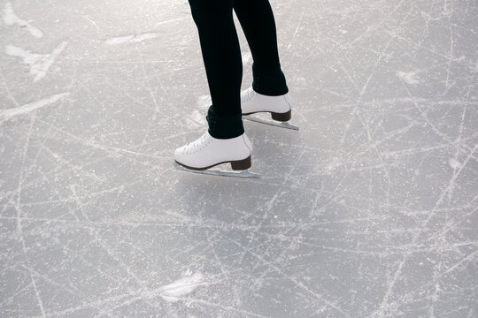 UGC of young woman skating on a lake in New England 