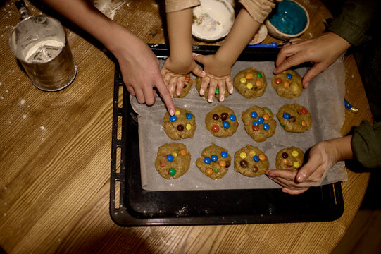 mom with children cooking a cookies