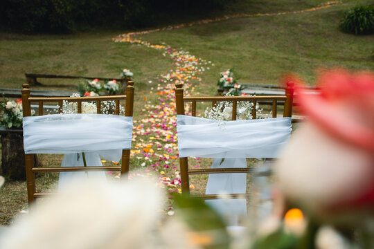 Decorated Chairs with Wedding Flowers and Petal Path