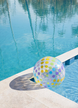 Colorful beach ball by a tranquil poolside
