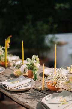 Outdoor dining setup with yellow candle accents