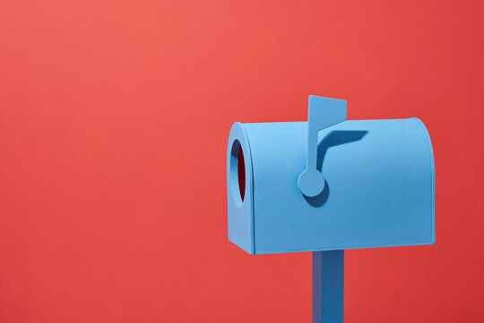 Blue mailbox on red background. minimalist concept