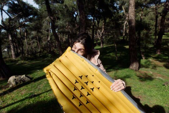young woman inflating an air mattress