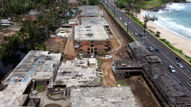 Aerial Pan of Coco Palms - Abandoned Historical Kauai Hotel in Disrepair with Waves and Neighboring Road