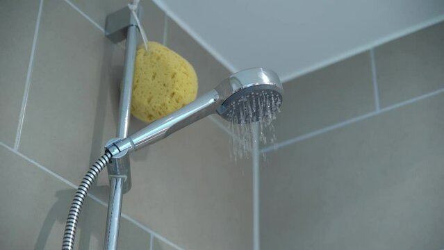 Water dropping from a shower head in slow motion