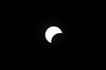 Partial Solar Eclipse against a dark sky. April 8th 2024 eclipse.