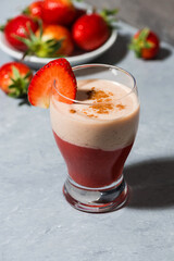 fresh strawberry yoghurt milkshake on table, vertical