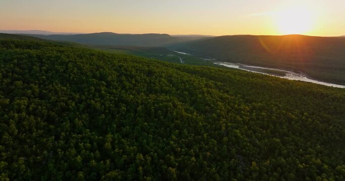 Aerial view rising over arctic Taiga and fells in Utsjoki, midnight sun in Finland