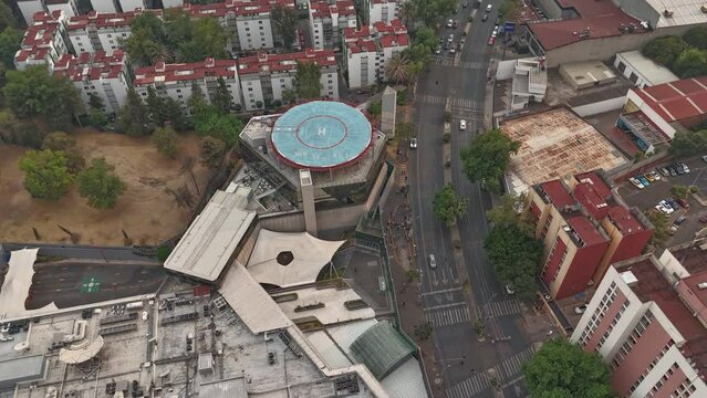 Hyperlapse aerial of southern area of Mexico City, heliport in middle of residential areas