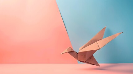 Origami Brown Paper Eagle on blue and pink background
