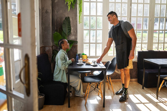 black woman having breakfast in a cafe