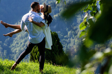 The sexy couple embraced passionately amidst the beauty of nature. Romantic kiss. Couple kiss on...