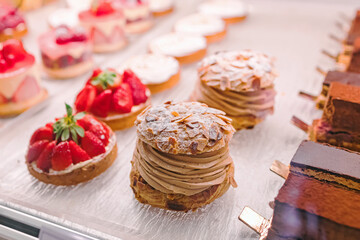 Delicious french desserts in the display of small pastry shop, Paris, France