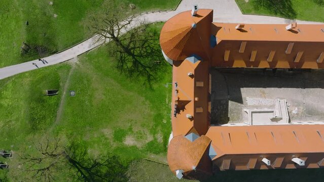Aerial establishing view of Bauska Medieval Castle and ruins, Musa and Memele rivers next to the castle, sunny spring day, birdseye drone dolly shot moving right