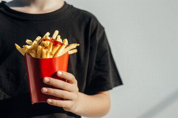 Hands of person holding french fries