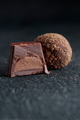 Delicious gourmet homemade dark chocolate candies from confectionery on black background