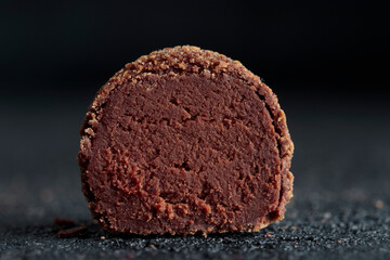Delicious gourmet homemade dark chocolate candy from confectionery on black background