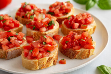 Homemade Bruschetta with Basil and Tomatoes on a Plate, side view.