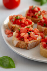 Homemade Bruschetta with Basil and Tomatoes on a Plate, side view.