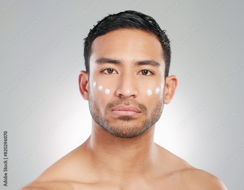 Sticker Cosmetics, man and facial cream in studio portrait for wellness, hygiene and grooming or cleaning. Male person, beauty product or lotion in grey background for health, smooth skin and moisture