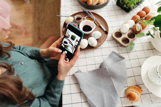 Woman Capturing Easter Docaration on Smartphone