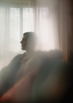 side profile of person alone in abstract blurry photo