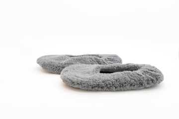 Fluffy gray home slippers isolated on white background. Bed shoes accessory footwear. Side view, close-up.