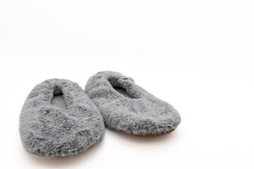 Fluffy gray home slippers isolated on white background. Bed shoes accessory footwear.