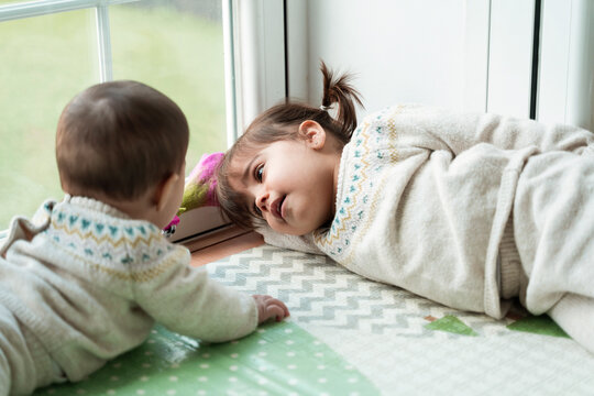 Little girl daydreaming by window