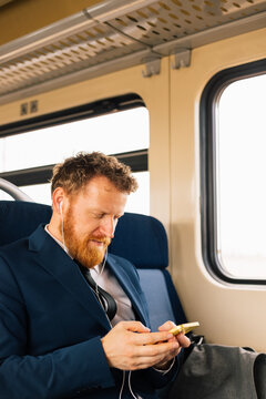 Man on train watching video