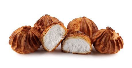 Cut in half and whole porophytroles with white cream isolated on a white background. Eclair with cream.