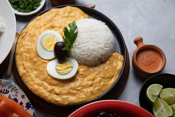 Aji de gallina chicken cream with rice and boiled eggs Buffet table full of lunch assorted dishes Peru Peruvian food