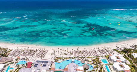 Aerial panorama of Punta Cana white sand beach. Residential buildings and many hotels on the shore of the turquoise Caribbean sea, Dominican Republic. Top place in the world for summer vacations 