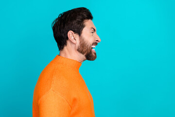 Profile side photo of angry mad man wear orange stylish clothes look empty space isolated on cyan...