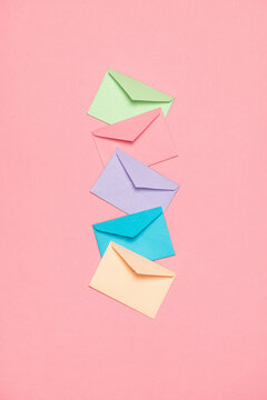 Colorful envelopes on pink. Communication, messaging, information.