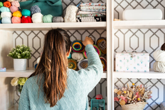 Woman sorting yarn in craft room